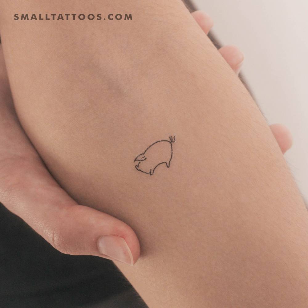 Minimalist little pig temporary tattoo placed on the inner forearm.