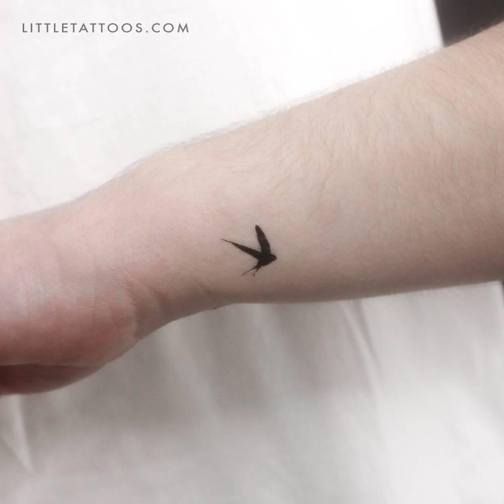 Small swallow temporary tattoo placed on the wrist.