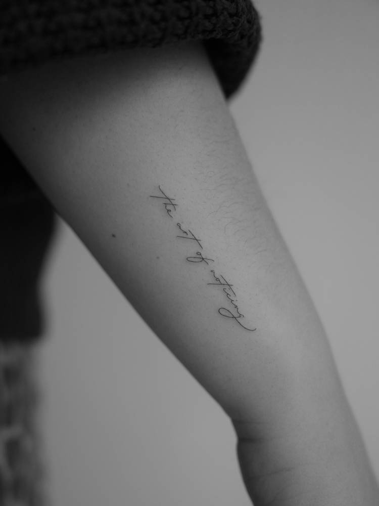 "The art of noticing" lettering tattoo located on the wrist.