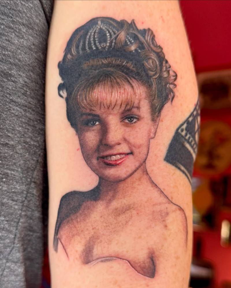 Laura Palmer portrait tattoo in realistic style located on the upper arm.