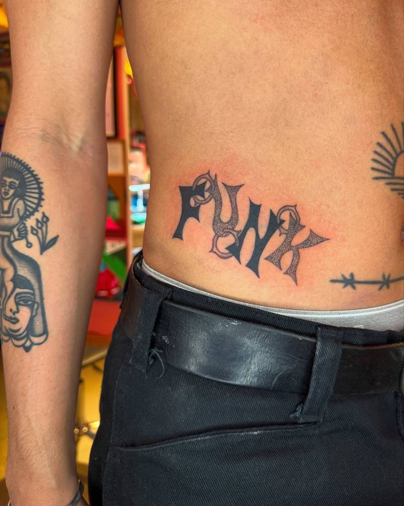Word funk tattoo located on the waist, done in illustrative style.