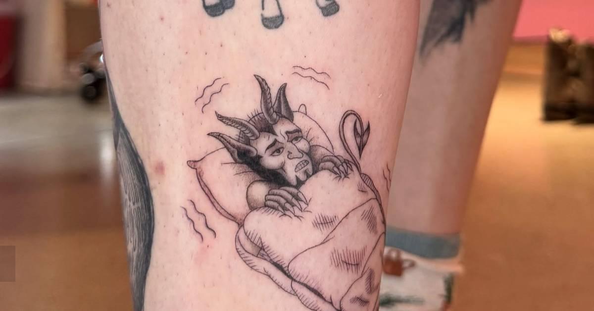Cold devil tattoo located on the shin, done in