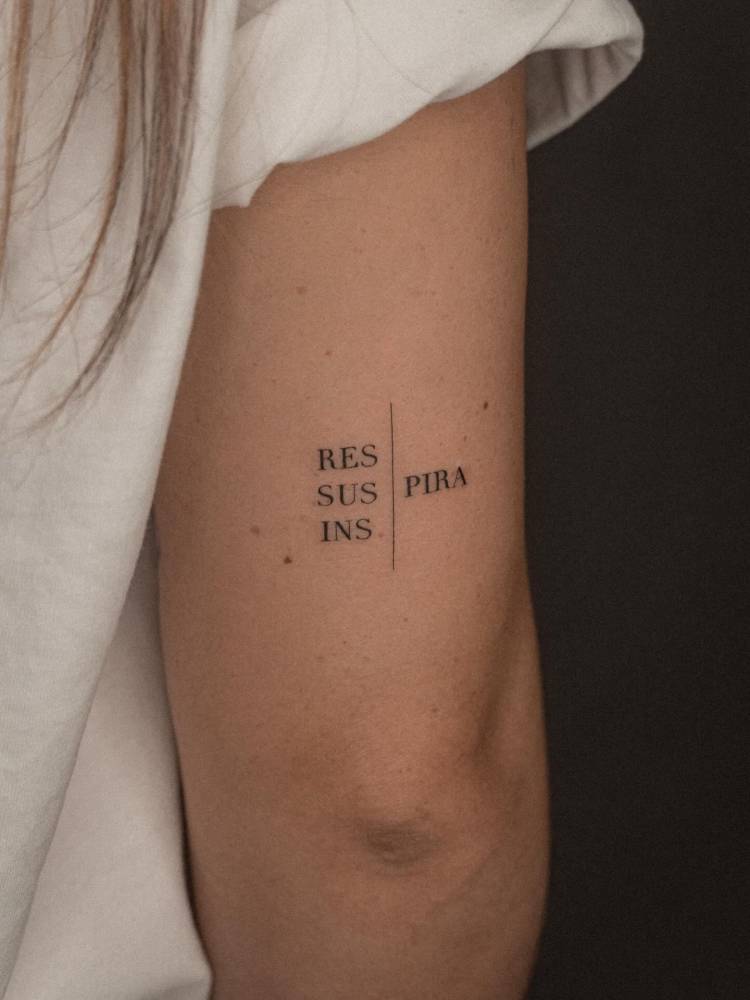 "Respira", "suspira" and "inspira" tattooed on the tricep.
