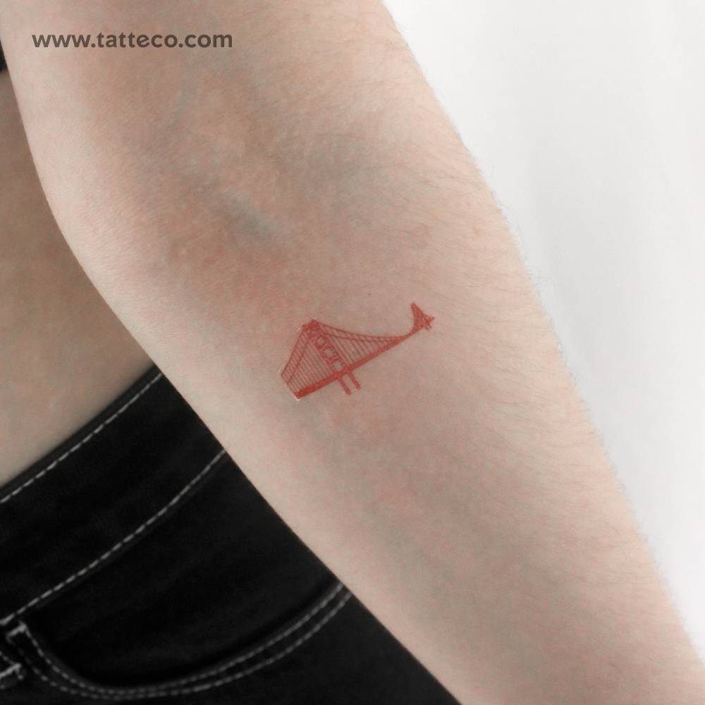 Red ink Golden Gate bridge temporary tattoo located on the inner forearm.