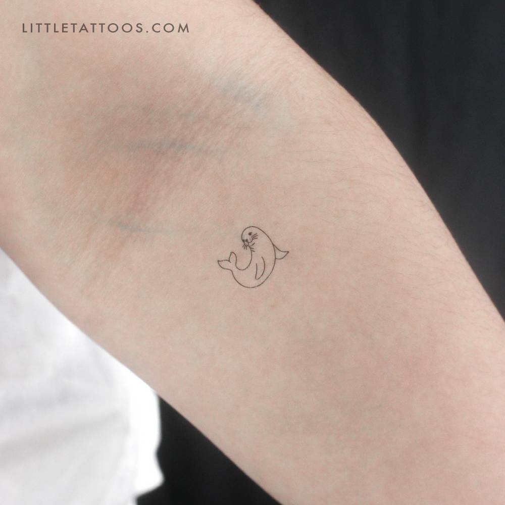 Fine line style seal temporary tattoo located on the inner forearm.