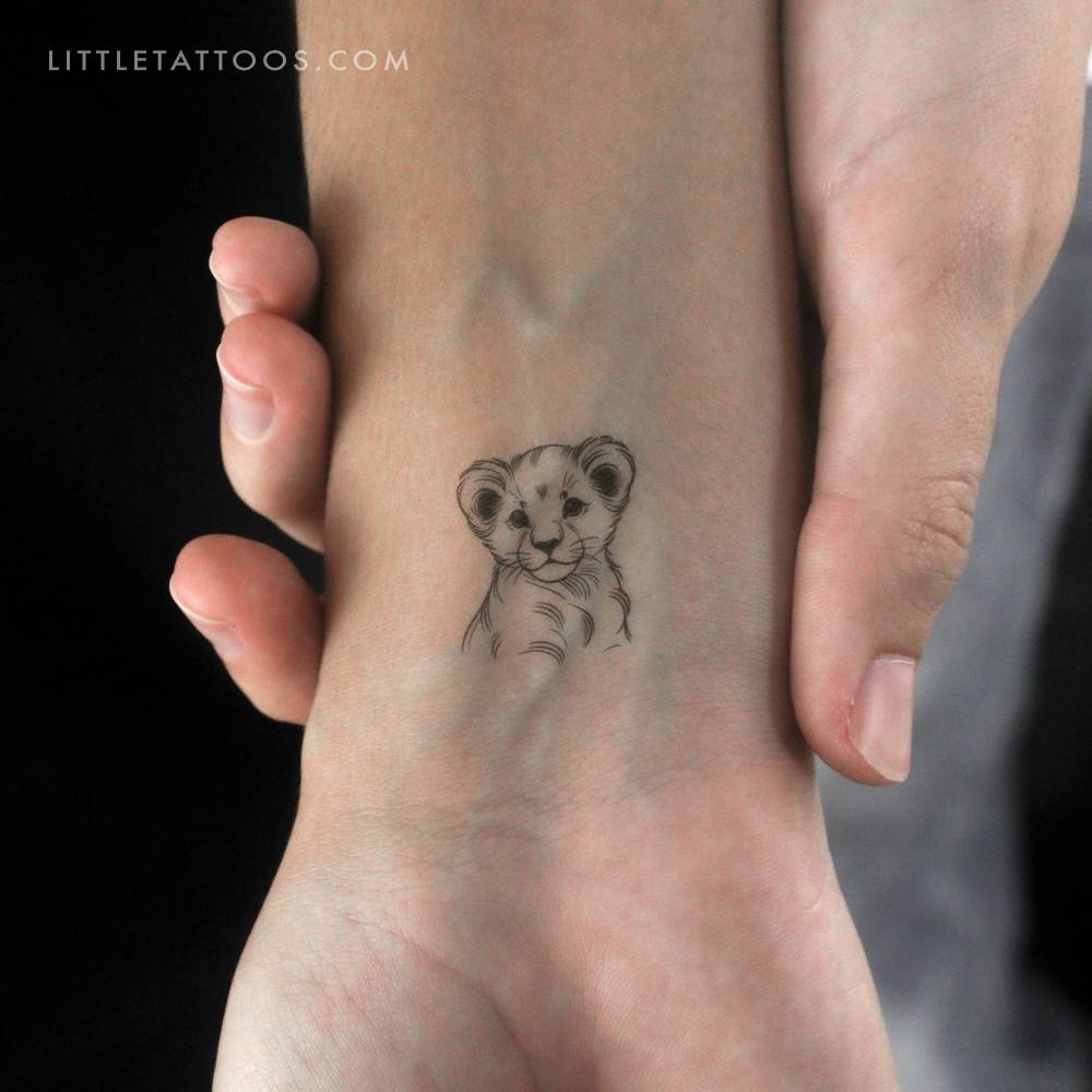 Lion cub portrait temporary tattoo located on the wrist.