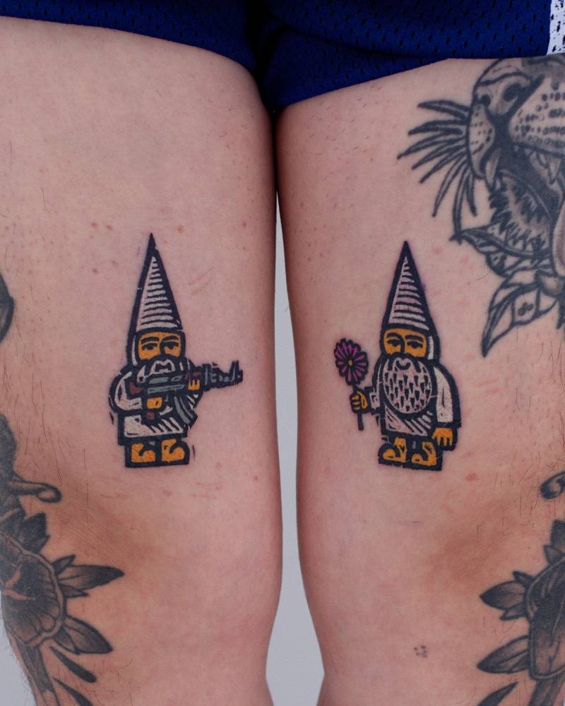 Individual matching gnomes tattooed on the thighs.