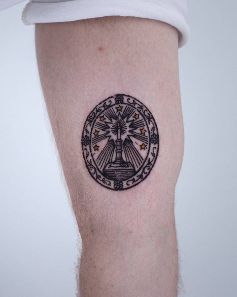 Crest tattoo in engraving style located on the inner arm.