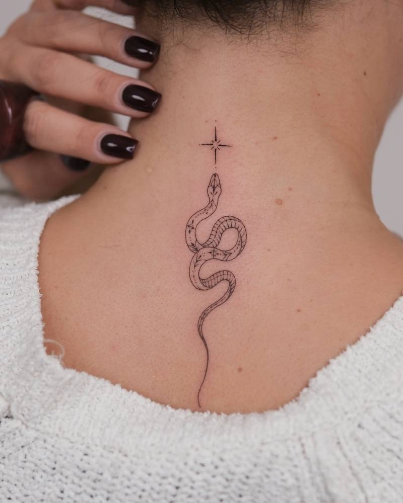 Snake and star tattoo located on the upper back, fine line style.