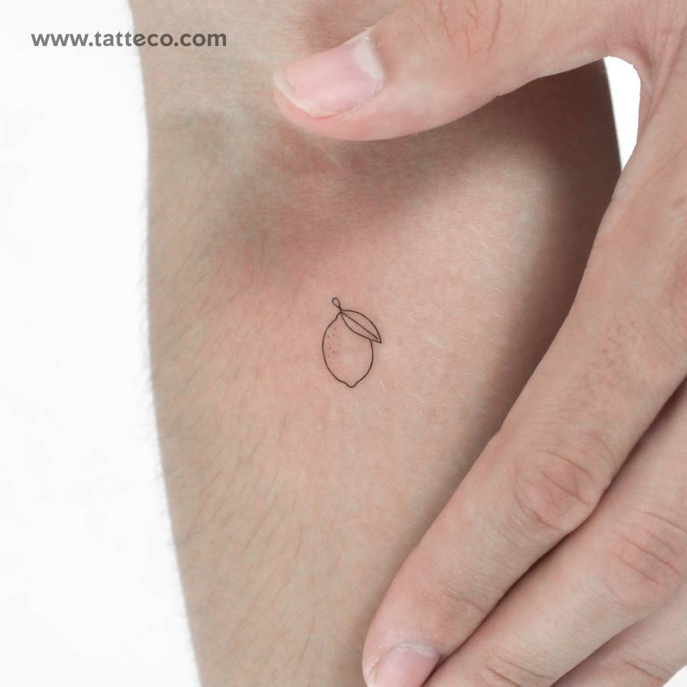 Tiny single line lemon temporary tattoo located on the inner forearm.