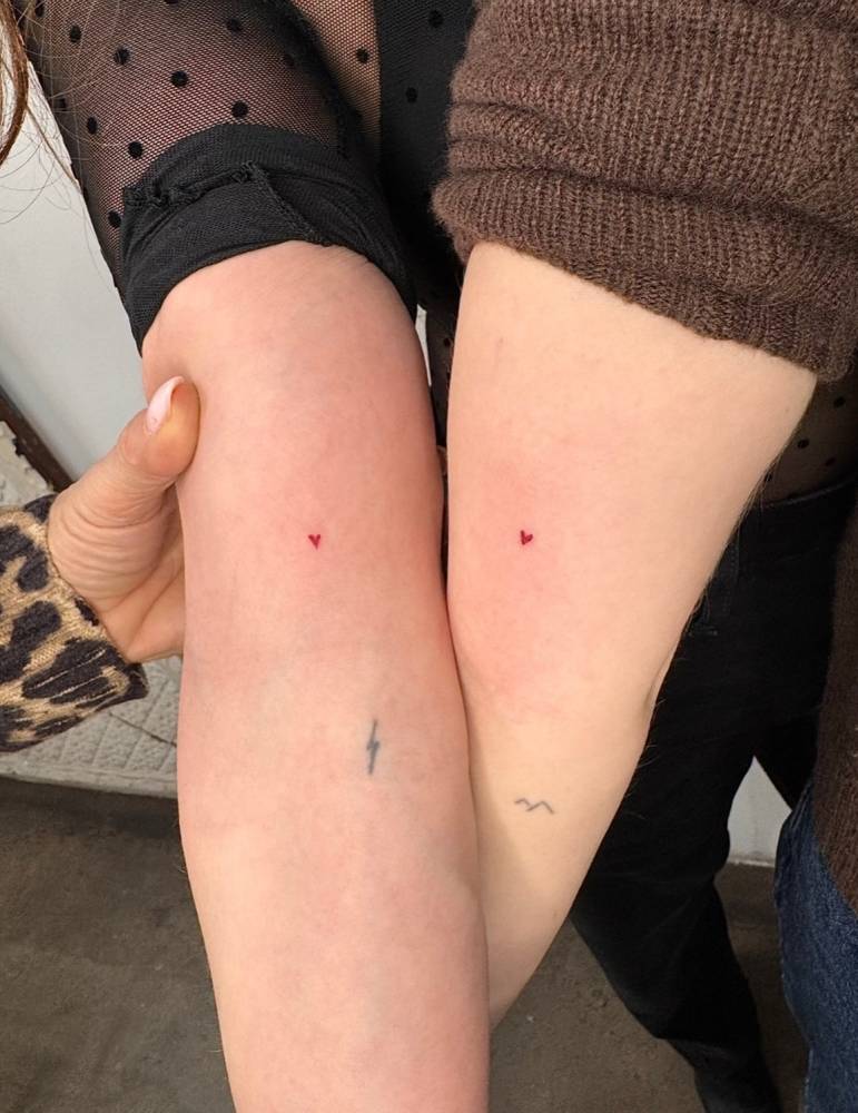 Matching minimalistic red heart tattoo for best friends.