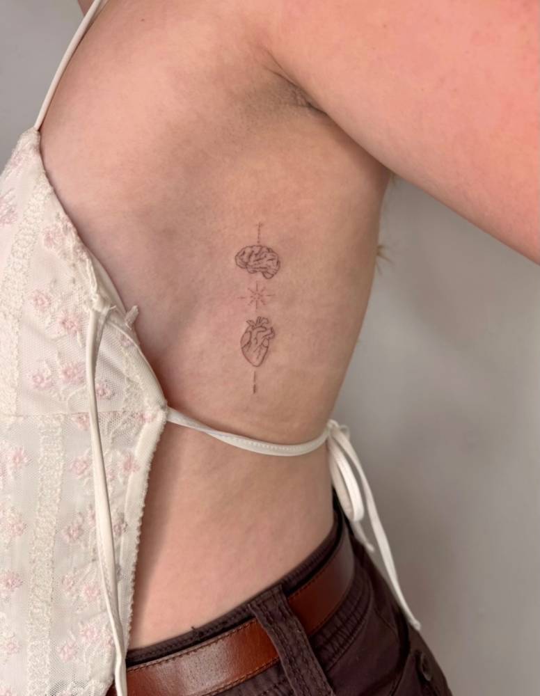 Single needle brain vs. heart tattoo located on the side boob.