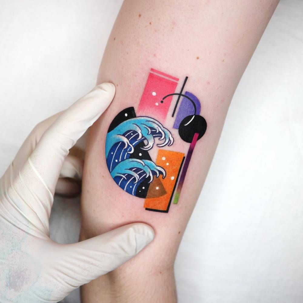 Pop art style 'The Great Wave' tattoo located on the upper arm.