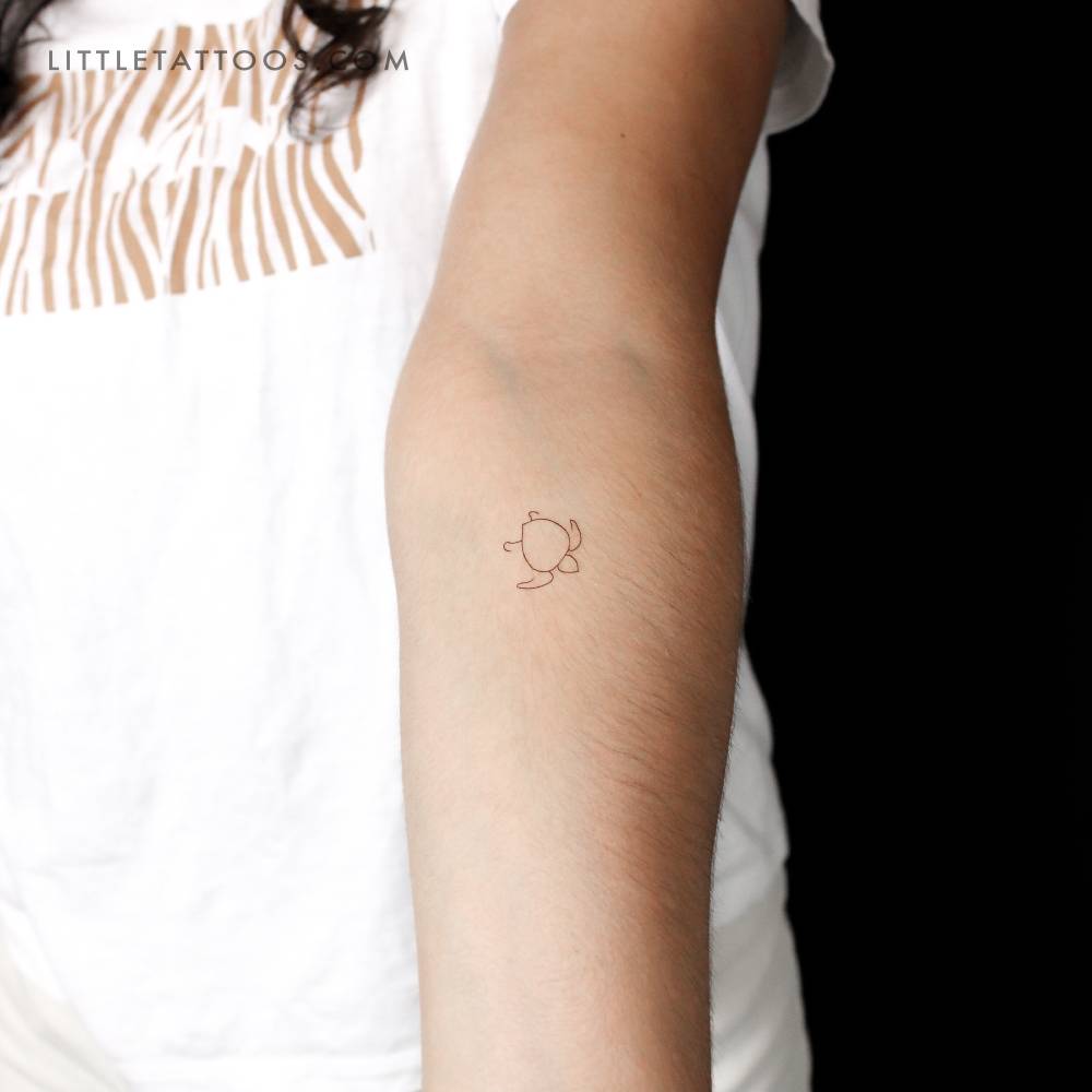 Minimalistic style turtle temporary tattoo located on the inner forearm.