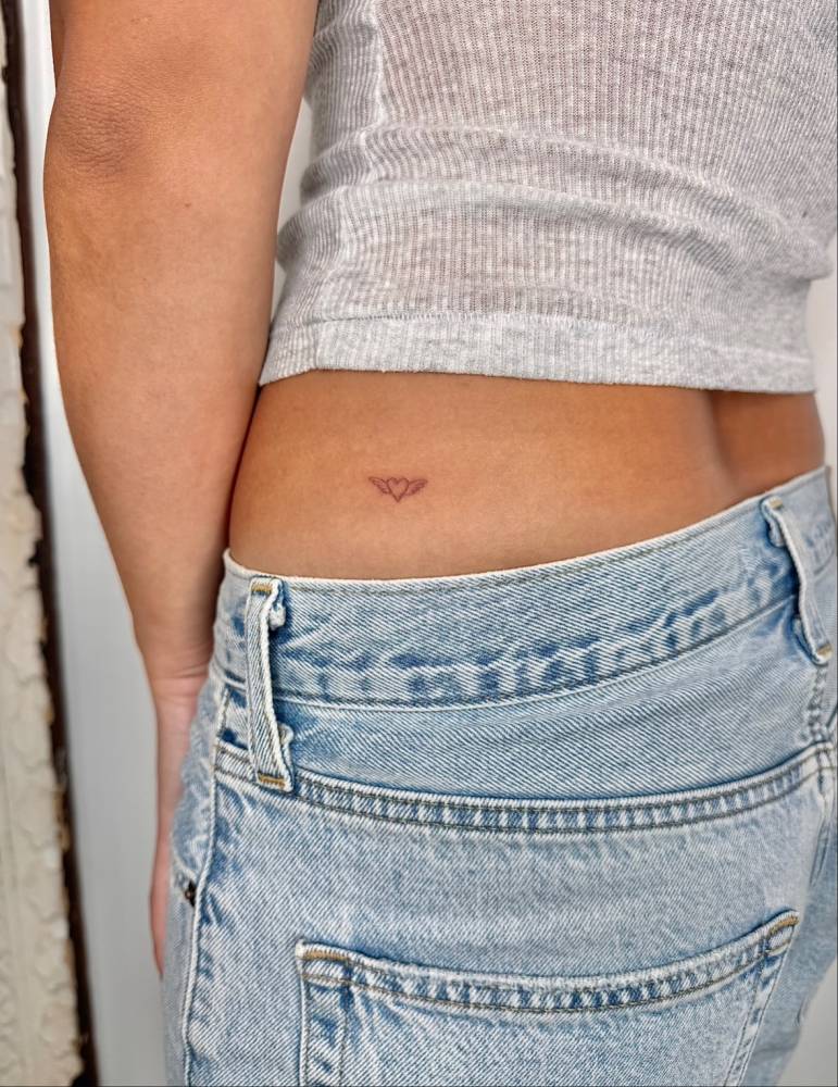 Heart and angel wings tattoo  located on the hip.