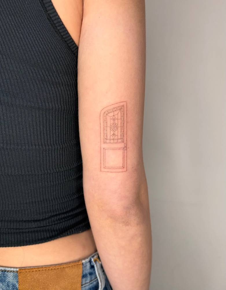 Single needle door tattoo placed on the tricep.