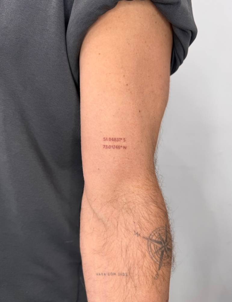 Coordinates tattoo located on the bicep.