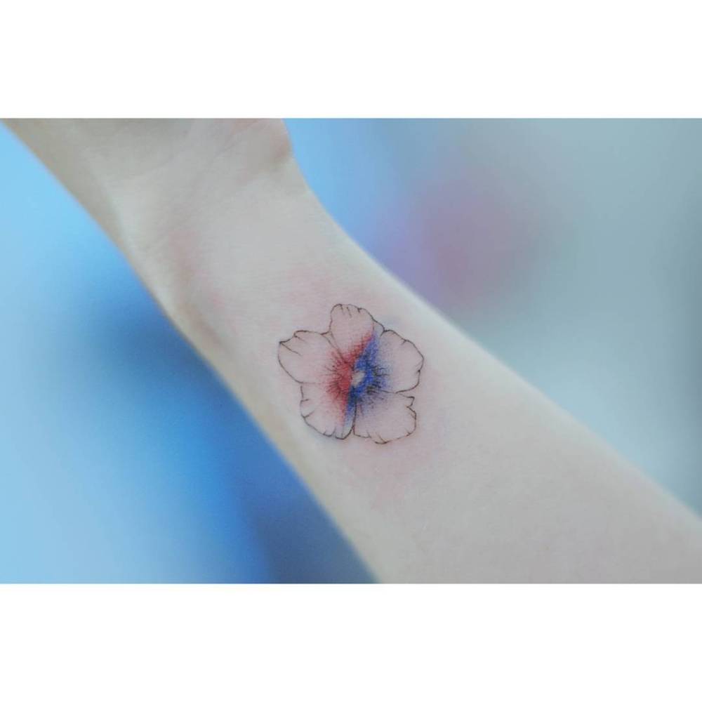Rose of Sharon tattoo located on the wrist, done in illustrative style.
