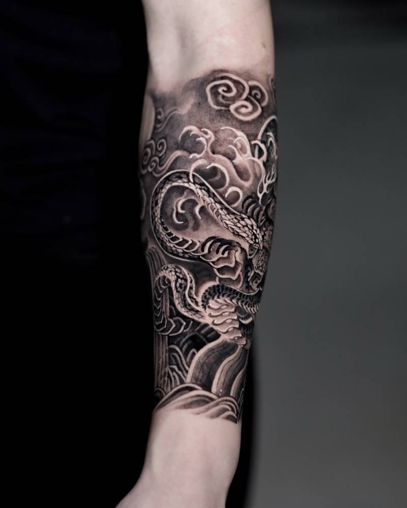 Snake tattoo in oriental style done on the forearm.