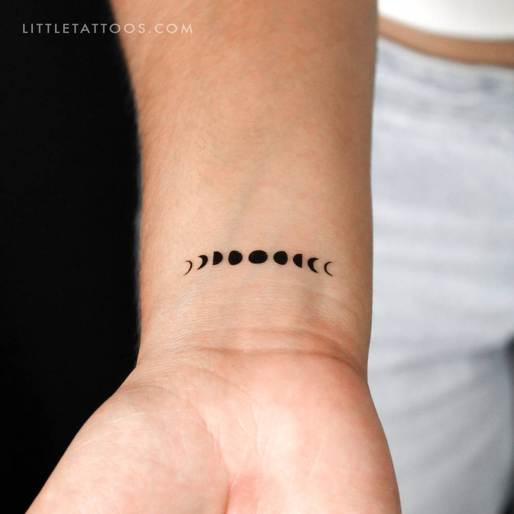 Moon phases temporary tattoo located on the wrist.