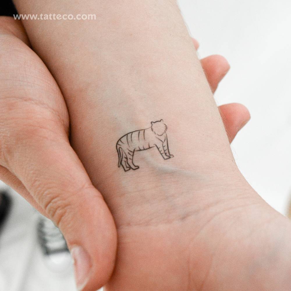 Minimalist tiger temporary tattoo placed on the wrist.