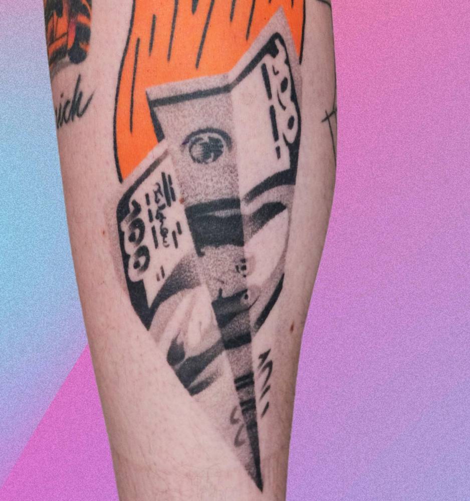 Dollar bill paper plane tattoo located on the calf.