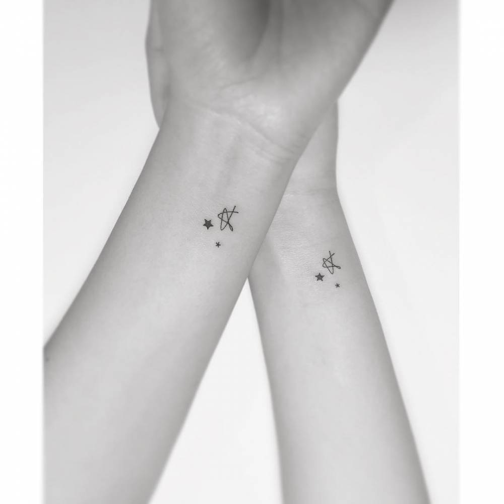 Matching stars tattoo in minimalistic style for best friends.