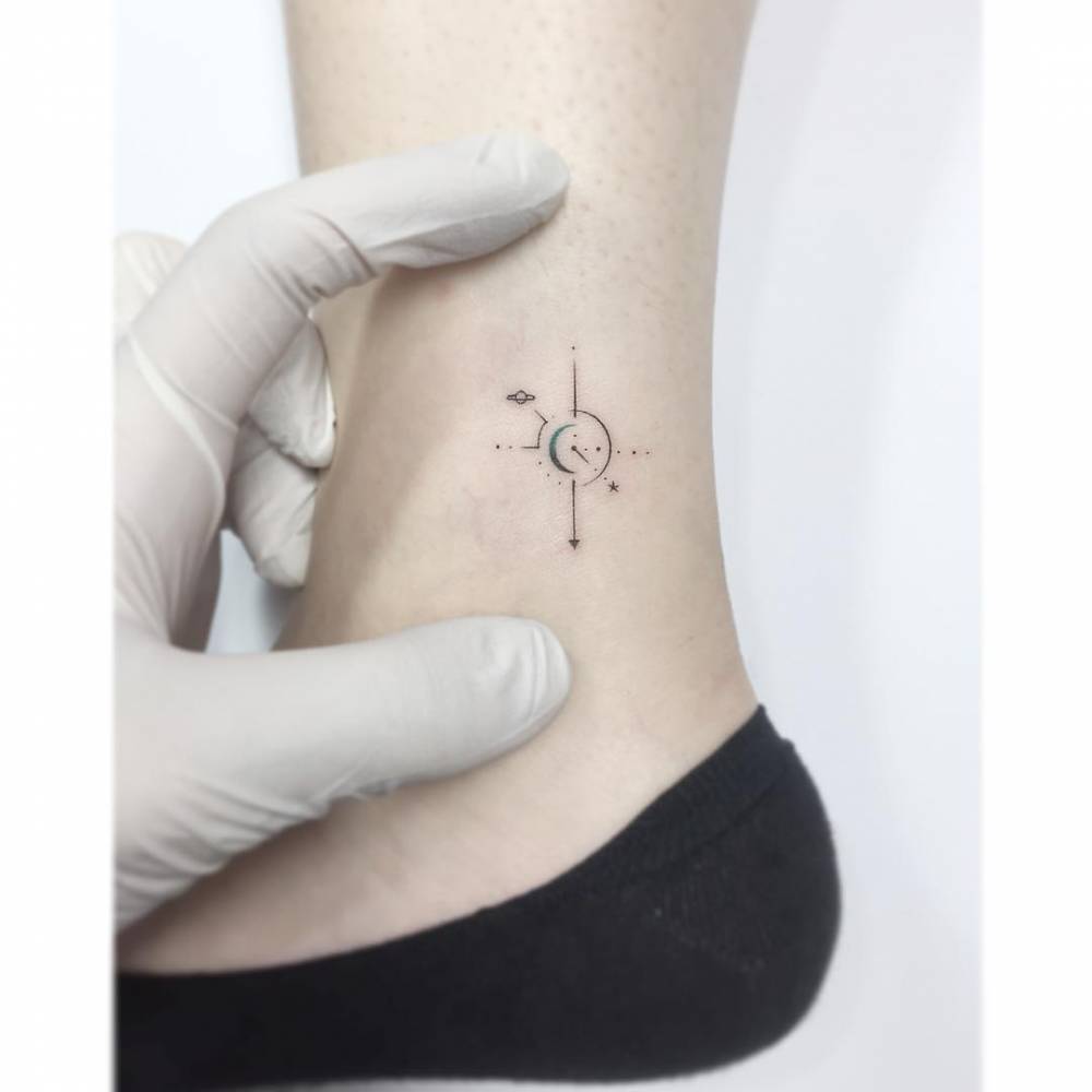 Compass rose tattoo done on the ankle, minimalistic style.