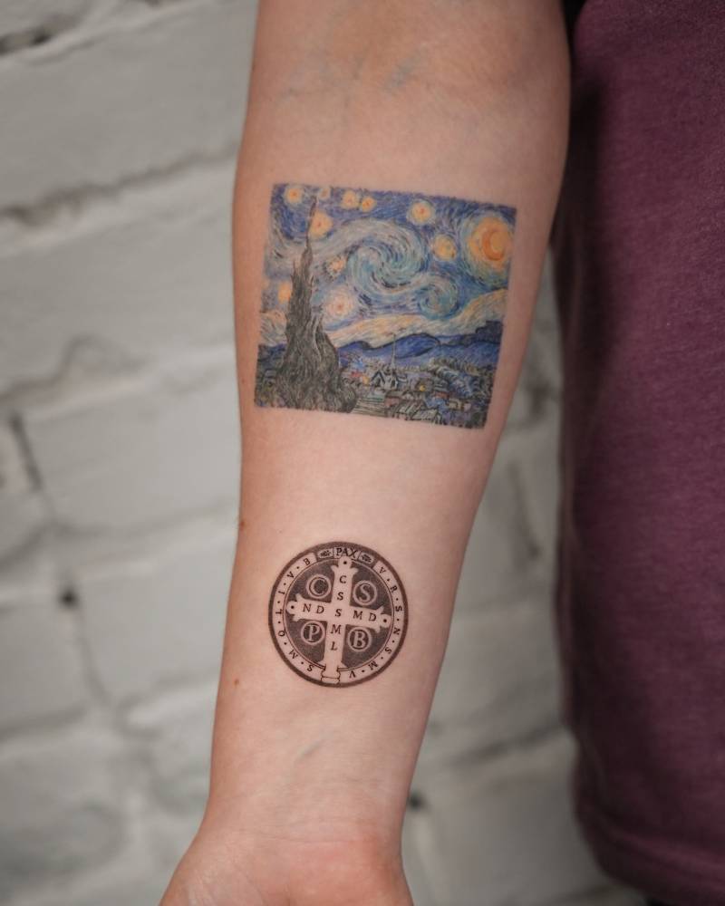 Illustrative style Saint Benedict Medal tattooed on the wrist.
