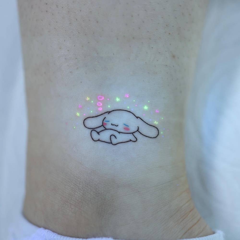 Cinnamoroll tattoo in cartoon style located on the ankle.