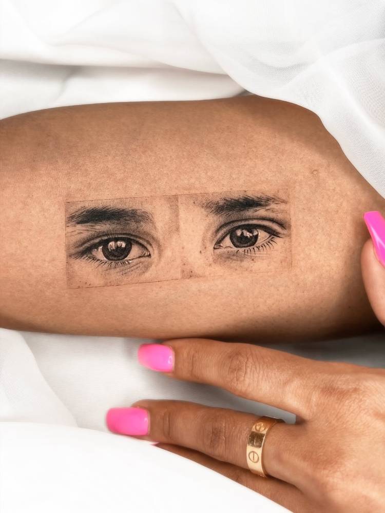 Eyes tattoo in micro-realistic style located on the inner arm.
