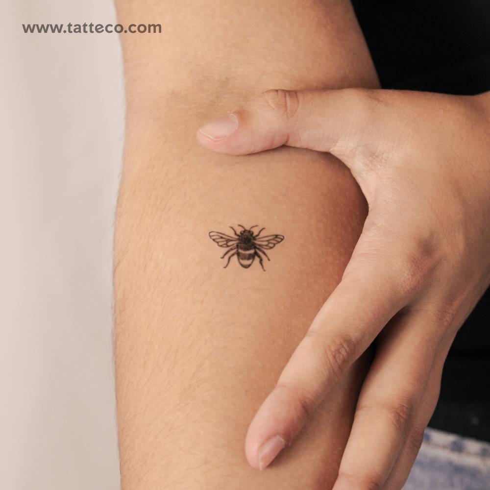 Hand-drawn bee semi-permanent tattoo located on the inner forearm.