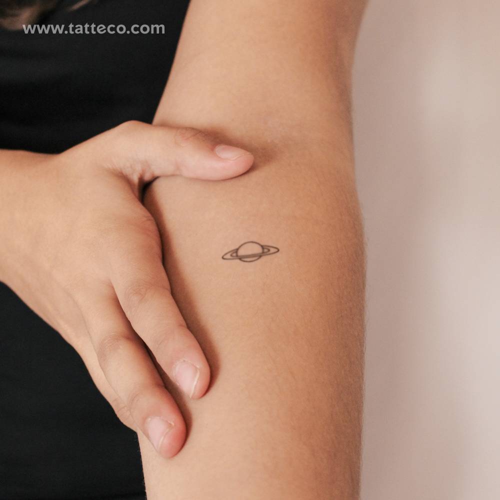 Saturn semi-permanent tattoo in minimalistic style.