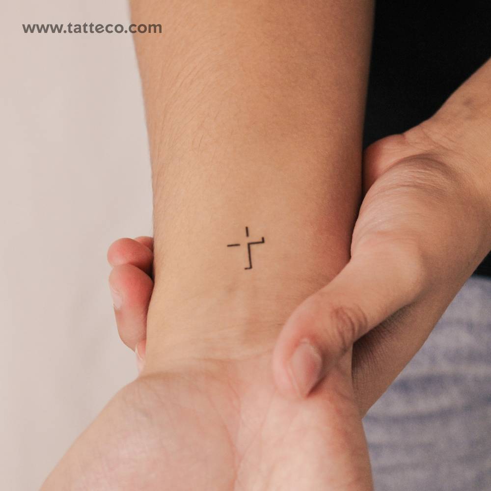 Cross shadow semi-permanent tattoo placed on the wrist.