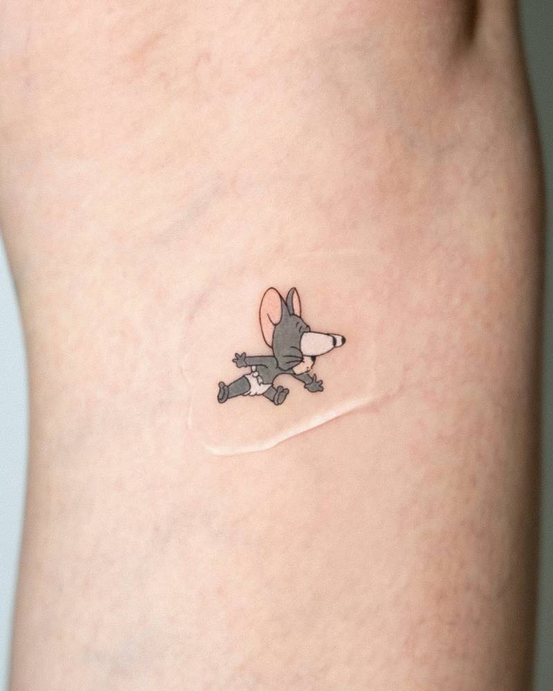 Cartoon style Jerry tattoo located on the inner arm.