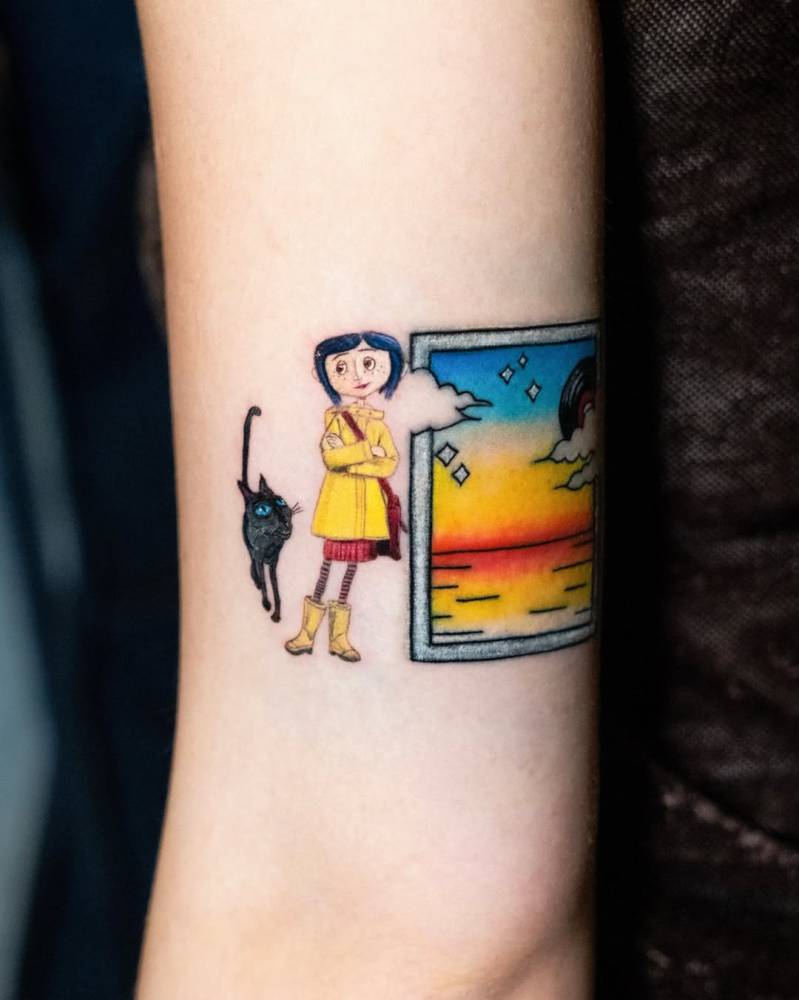 Coraline tattoo located on the tricep, cartoon style.
