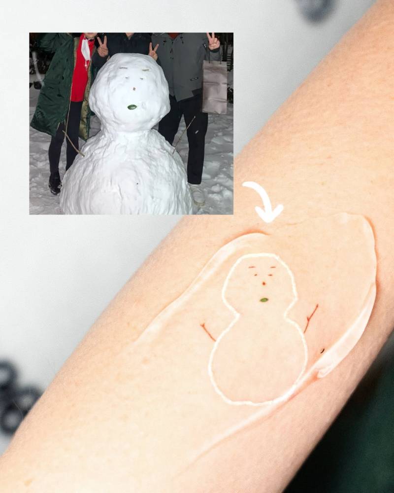 Cartoon style snowman tattoo located on the forearm.