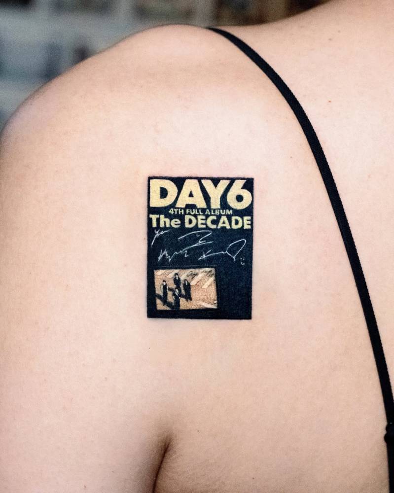 Day6 album cover tattooed on the shoulder blade.