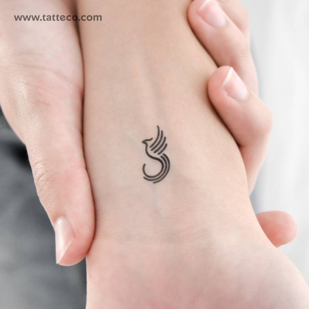 Minimalist phoenix temporary tattoo located on the wrist.