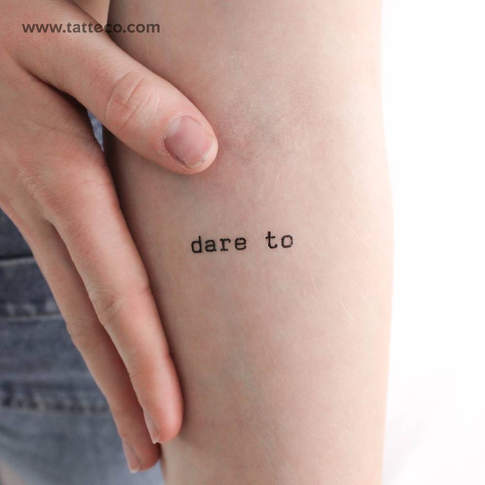 Dare to temporary tattoo located on the inner forearm.
