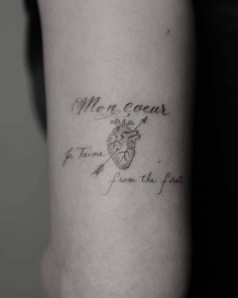 Anatomical heart and arrow tattoo located on Karen Fukuhara's tricep.