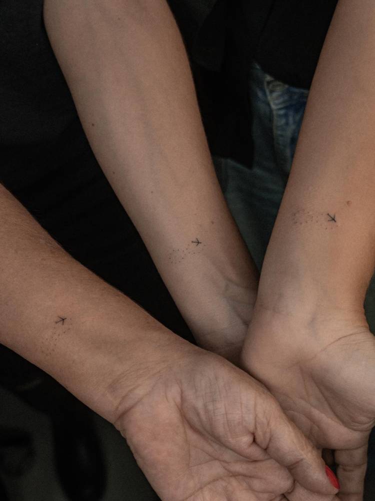 Matching infinity symbol and plane tattoo for mother and daughters.