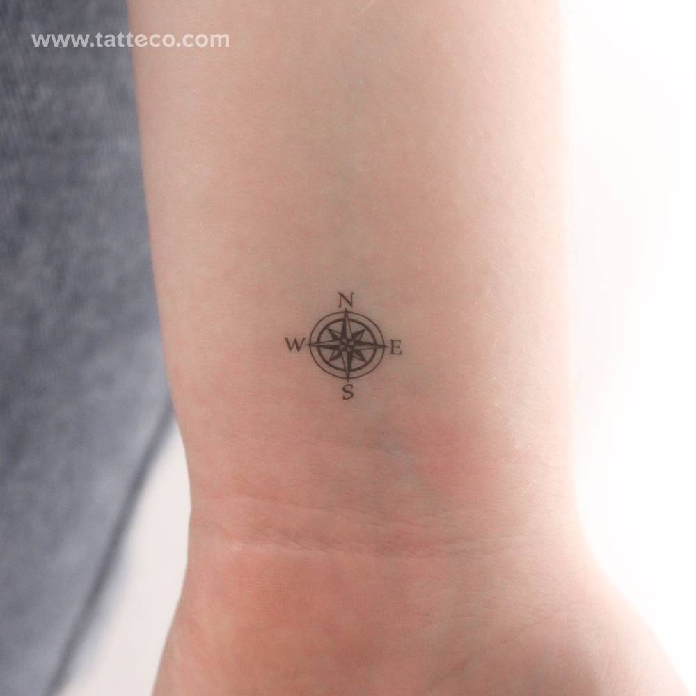 Tiny compass rose temporary tattoo located on the wrist.