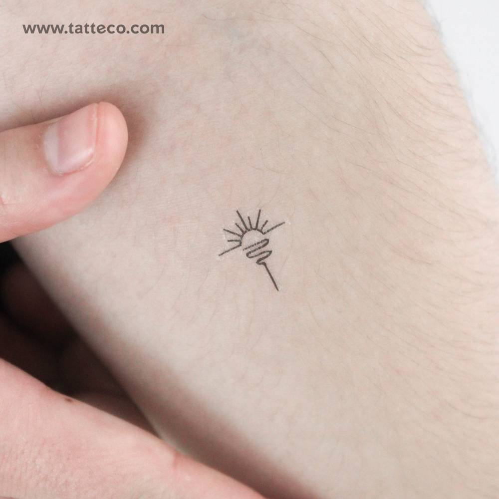 Minimalist sea sunrise temporary tattoo located on the inner forearm.