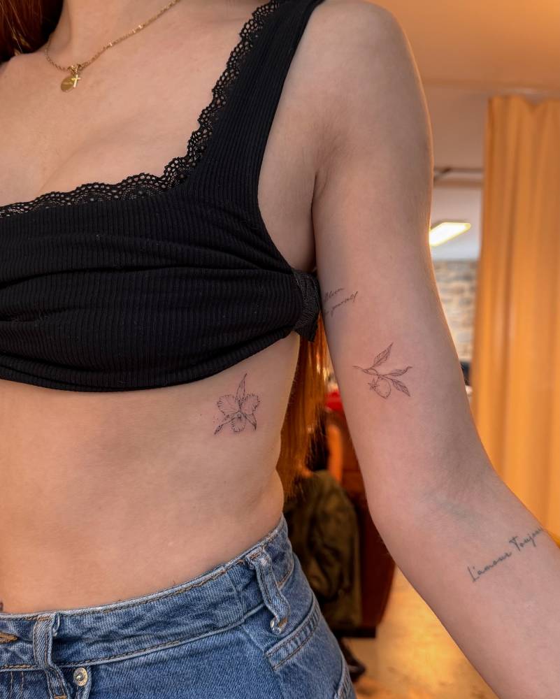 Orchid and lemon tattoos done in fine line style.