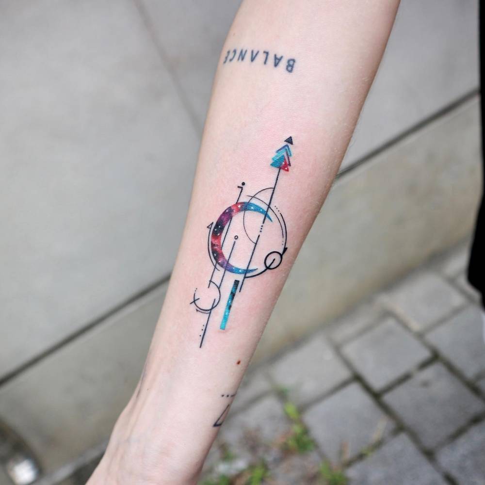 Graphic style crescent moon tattoo located on the inner forearm.