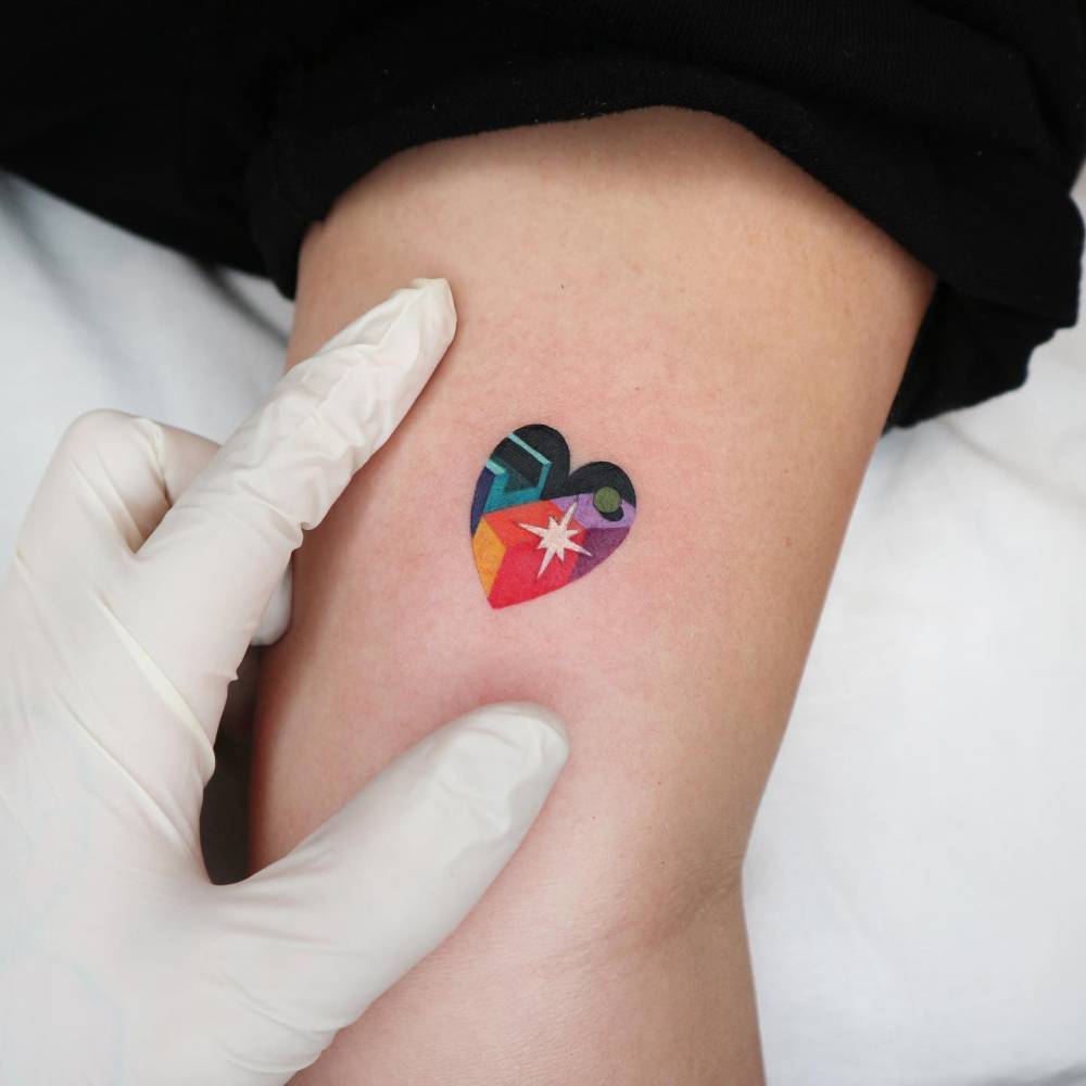 Abstract style heart tattoo located on the inner arm.