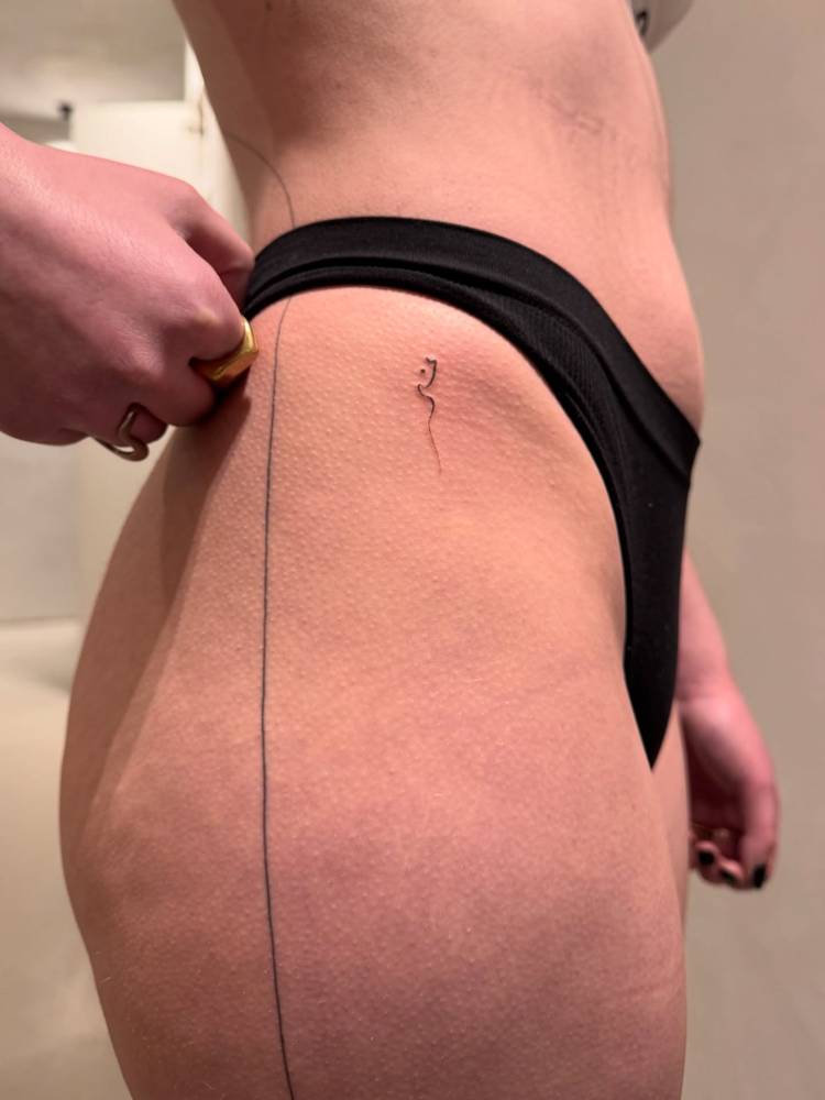 Small abatract ornamental design tattooed on the hip.