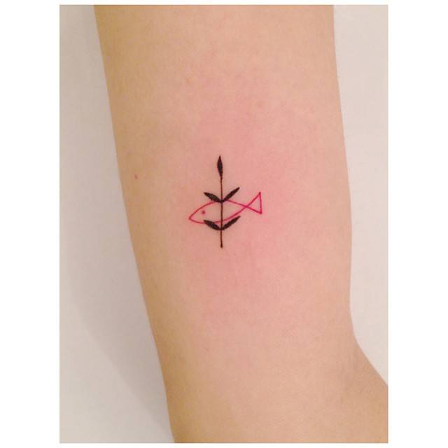 Minimalist style sprout and fish tattoo located on the wrist.