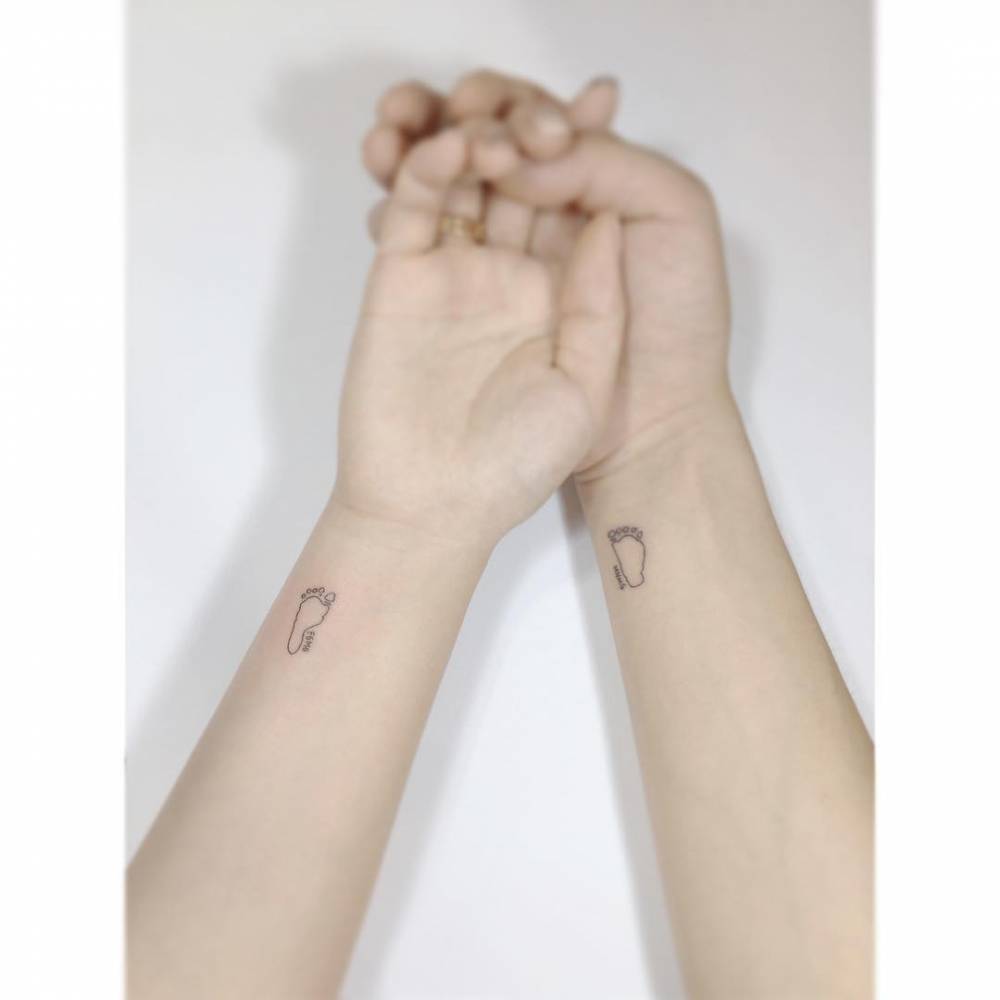 Matching baby footprint tattoo for couple.